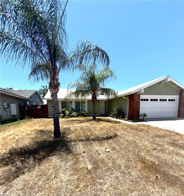 24423 Dunlavy Ct, Moreno Valley, CA 92557 - ranch-style house with board and batten siding, an attached garage, and concrete driveway