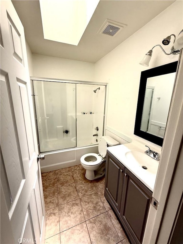 24423 Dunlavy Ct, Moreno Valley, CA 92557 - full bathroom with vanity, bath / shower combo with glass door, tile patterned floors, and a skylight