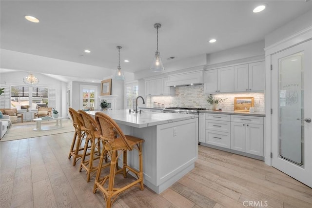 1605 Steinhart Ave, Redondo Beach, CA 90278 - kitchen with white cabinetry, light wood-style floors, recessed lighting, decorative backsplash, and open floor plan