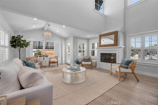 1605 Steinhart Ave, Redondo Beach, CA 90278 - living area featuring wood finished floors, plenty of natural light, a chandelier, a glass covered fireplace, and beam ceiling