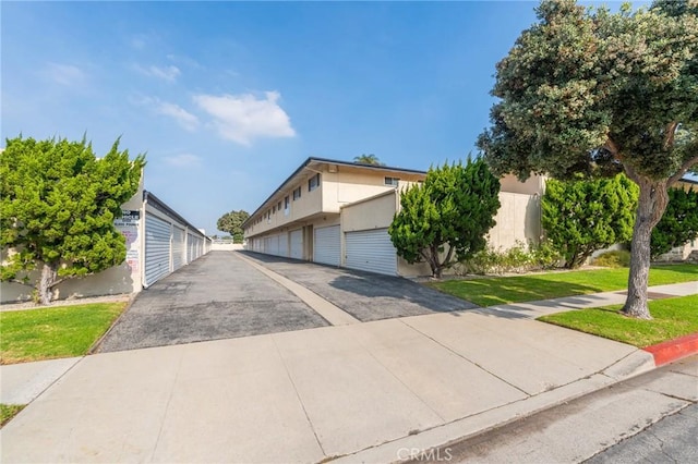 3115 Merrill Dr Unit 59, Torrance, CA 90503 - view of front of property with community garages, a front lawn, and stucco siding
