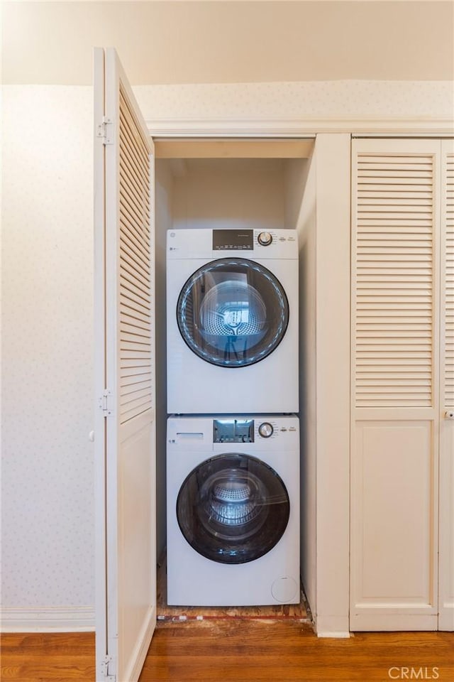 3115 Merrill Dr Unit 59, Torrance, CA 90503 - washroom featuring stacked washing machine and dryer, wood finished floors, and wallpapered walls