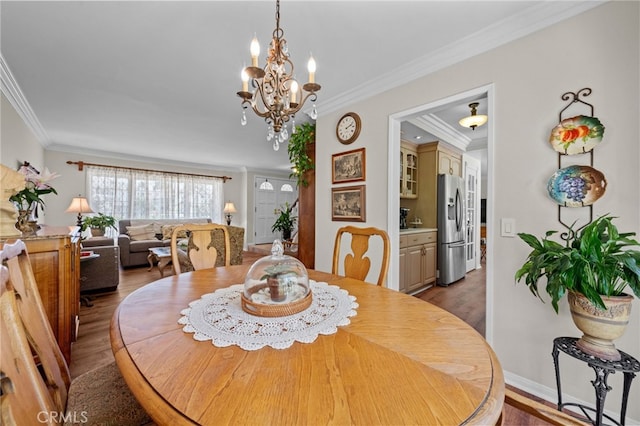 18911 Crimson Cir, Huntington Beach, CA 92646 - dining space featuring wood finished floors, ornamental molding, and a chandelier