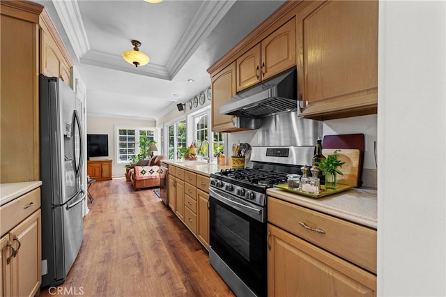 18911 Crimson Cir, Huntington Beach, CA 92646 - kitchen with stainless steel appliances, crown molding, wood finished floors, under cabinet range hood, and light countertops