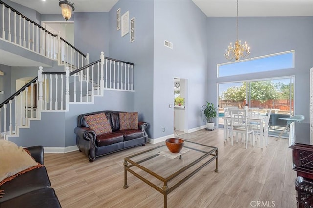 3143 Tourmaline Ln, Palmdale, CA 93550 - living area featuring a towering ceiling, a chandelier, wood finished floors, and stairway