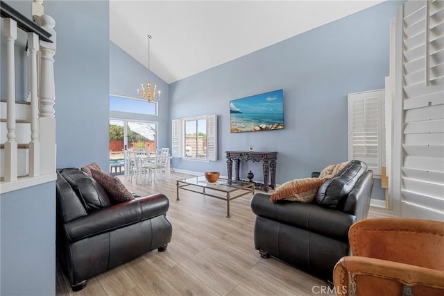 3143 Tourmaline Ln, Palmdale, CA 93550 - living area with high vaulted ceiling, a chandelier, and wood finished floors