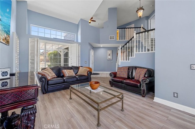 3143 Tourmaline Ln, Palmdale, CA 93550 - living area with a high ceiling, wood finished floors, and stairway