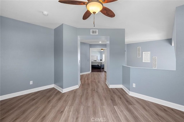 3143 Tourmaline Ln, Palmdale, CA 93550 - unfurnished room featuring ceiling fan, wood finished floors, and a smoke detector