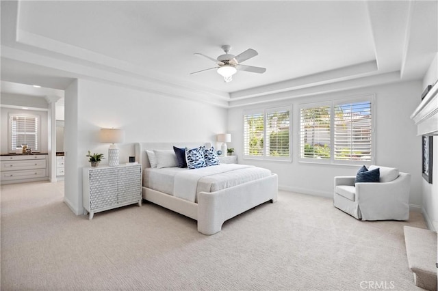 2175 Palmer Pl, Tustin, CA 92782 - bedroom featuring a raised ceiling, light colored carpet, ceiling fan, and a fireplace with raised hearth
