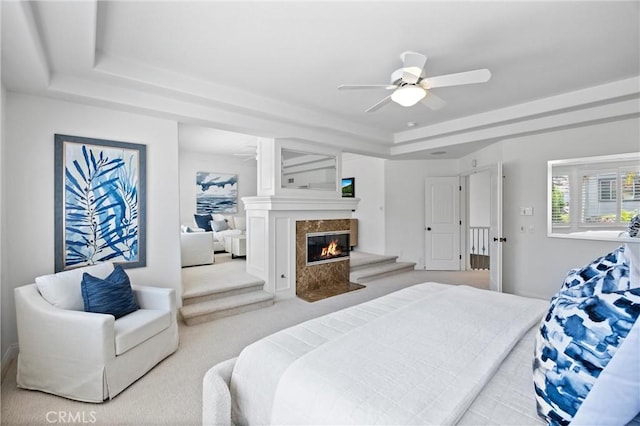 2175 Palmer Pl, Tustin, CA 92782 - carpeted bedroom featuring a tray ceiling, a high end fireplace, and ceiling fan