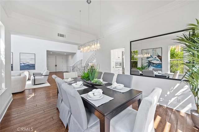 2175 Palmer Pl, Tustin, CA 92782 - dining area featuring stairway, ornamental molding, hardwood / wood-style floors, and a chandelier