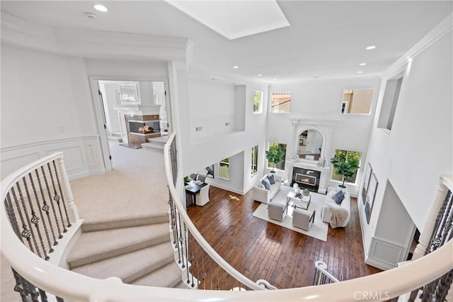 2175 Palmer Pl, Tustin, CA 92782 - living room with a glass covered fireplace, hardwood / wood-style flooring, recessed lighting, stairway, and crown molding