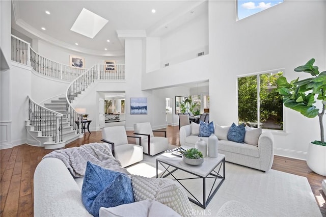 2175 Palmer Pl, Tustin, CA 92782 - living room featuring a towering ceiling, stairway, crown molding, a skylight, and recessed lighting