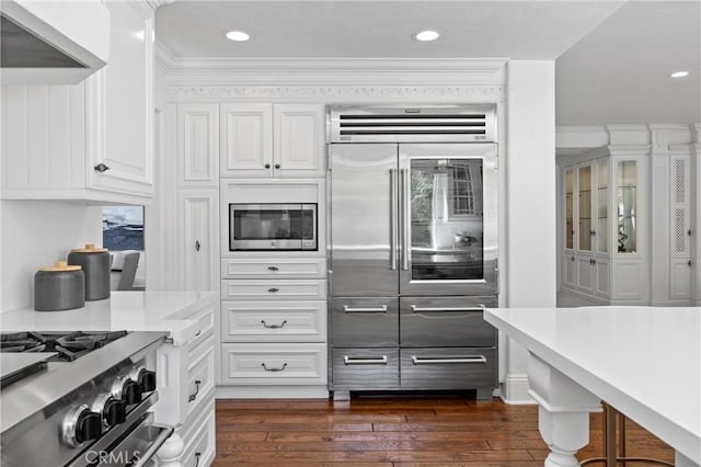 2175 Palmer Pl, Tustin, CA 92782 - kitchen with built in appliances, white cabinetry, light countertops, crown molding, and recessed lighting