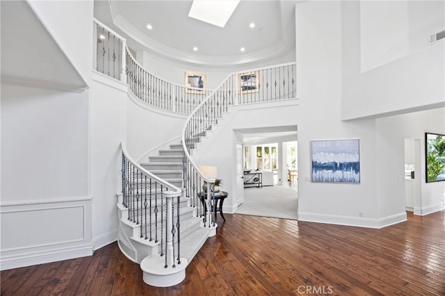 2175 Palmer Pl, Tustin, CA 92782 - stairway with a skylight, hardwood / wood-style floors, crown molding, a towering ceiling, and recessed lighting