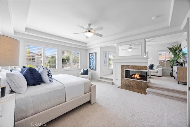 2175 Palmer Pl, Tustin, CA 92782 - bedroom with a raised ceiling, a premium fireplace, carpet flooring, and a ceiling fan