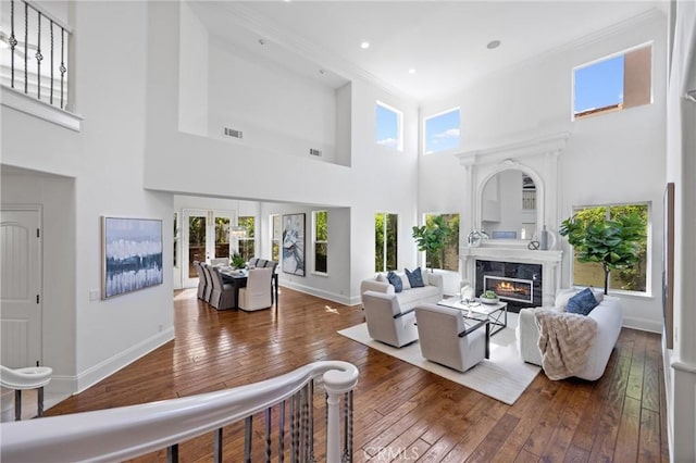 2175 Palmer Pl, Tustin, CA 92782 - living room with plenty of natural light, a premium fireplace, hardwood / wood-style flooring, a high ceiling, and ornamental molding