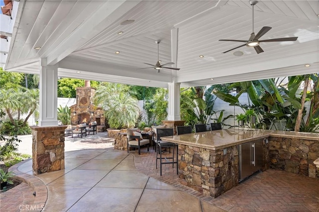 2175 Palmer Pl, Tustin, CA 92782 - view of patio with an outdoor stone fireplace, an outdoor kitchen, and ceiling fan