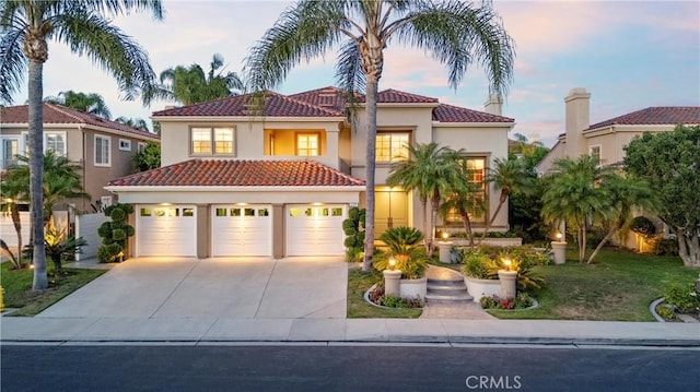 2175 Palmer Pl, Tustin, CA 92782 - mediterranean / spanish home featuring a tile roof, stucco siding, driveway, a garage, and a lawn