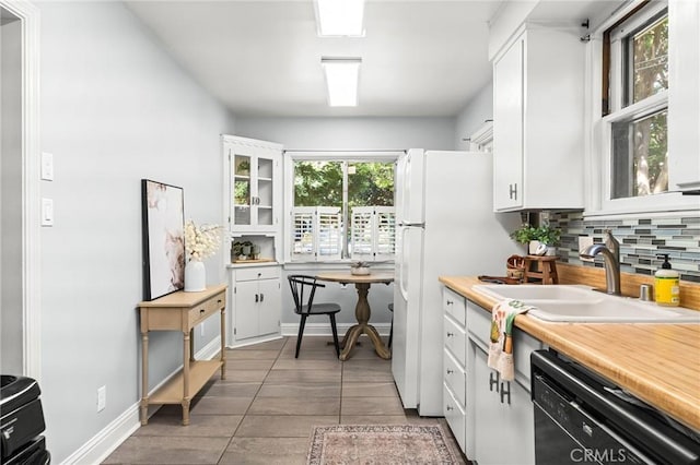 1168 Laburnum Ave, Chico, CA 95926 - kitchen featuring black dishwasher, decorative backsplash, and white cabinetry