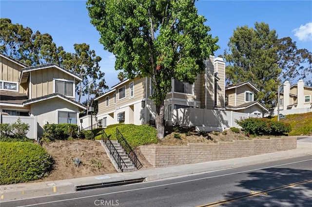 1007 Flintlock Rd, Diamond Bar, CA 91765 - view of front of property with board and batten siding, a residential view, and stairway