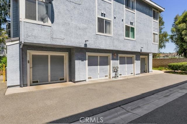 26966 Flo Ln Unit 319, Canyon Country, CA 91351 - rear view of house with stucco siding
