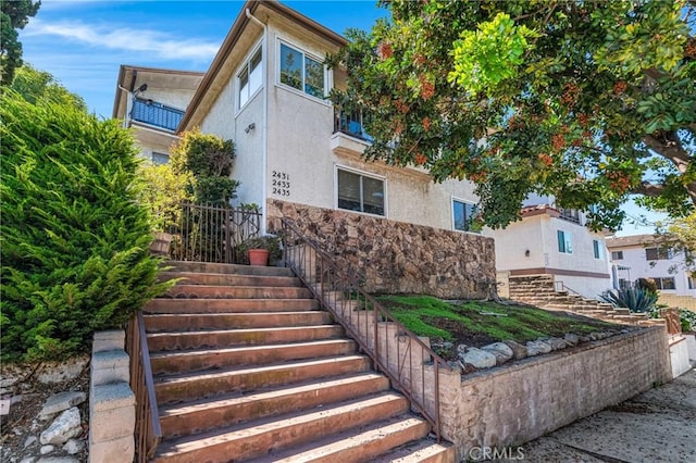 2433 S Gaffey St, San Pedro, CA 90731 - view of front of house with stairway, stucco siding, and stone siding