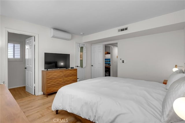 2433 S Gaffey St, San Pedro, CA 90731 - bedroom featuring a wall unit AC and light wood-type flooring