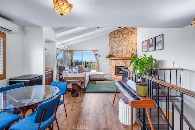 2433 S Gaffey St, San Pedro, CA 90731 - living room featuring wood finished floors, a stone fireplace, and a wall unit AC