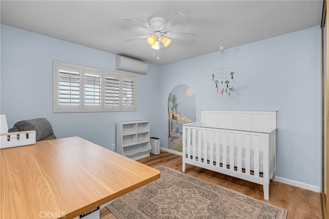 2433 S Gaffey St, San Pedro, CA 90731 - bedroom featuring a wall unit AC, wood finished floors, and a ceiling fan