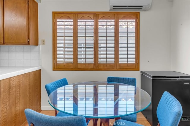 2433 S Gaffey St, San Pedro, CA 90731 - dining area with a wall mounted air conditioner, wood finished floors, and healthy amount of natural light