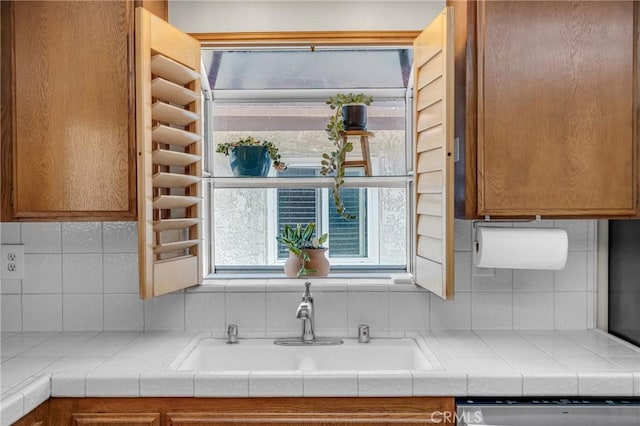 2433 S Gaffey St, San Pedro, CA 90731 - kitchen featuring stainless steel dishwasher, tasteful backsplash, brown cabinets, and tile countertops