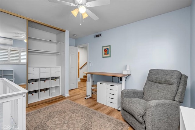 2433 S Gaffey St, San Pedro, CA 90731 - bedroom with wood finished floors, a wall unit AC, a closet, and a ceiling fan