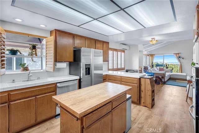 2433 S Gaffey St, San Pedro, CA 90731 - kitchen featuring stainless steel appliances, a peninsula, an AC wall unit, healthy amount of natural light, and recessed lighting