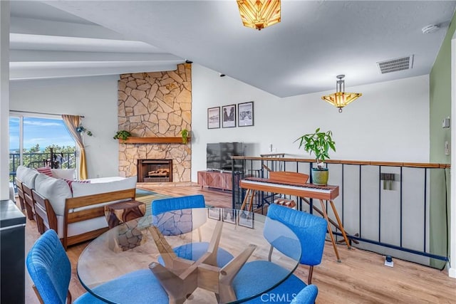 2433 S Gaffey St, San Pedro, CA 90731 - dining area with lofted ceiling, wood finished floors, and a fireplace
