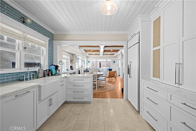 6025 E Ocean Blvd, Long Beach, CA 90803 - kitchen with coffered ceiling, ornamental molding, plenty of natural light, white cabinetry, and a peninsula