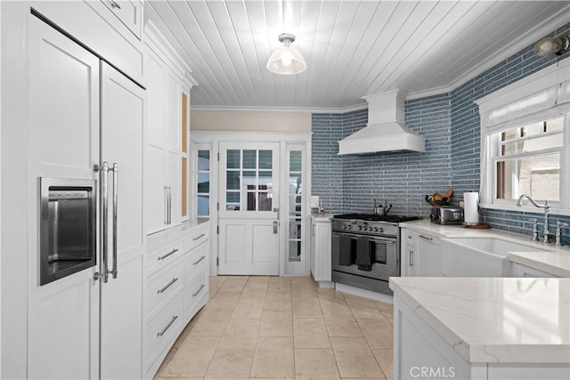 6025 E Ocean Blvd, Long Beach, CA 90803 - kitchen featuring stainless steel stove, premium range hood, ornamental molding, light stone counters, and white cabinetry