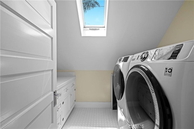 6025 E Ocean Blvd, Long Beach, CA 90803 - laundry area with washing machine and dryer, a skylight, and cabinet space