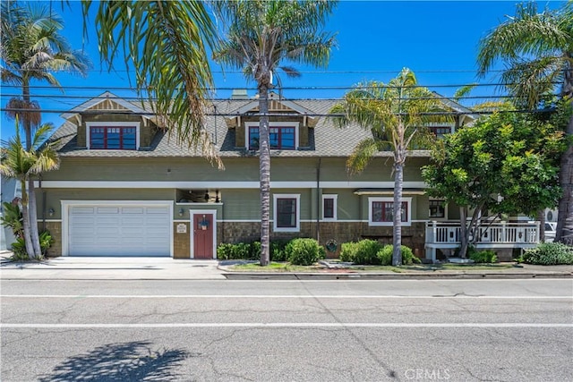 6025 E Ocean Blvd, Long Beach, CA 90803 - view of front facade featuring an attached garage and concrete driveway