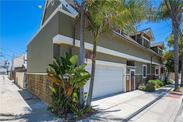 6025 E Ocean Blvd, Long Beach, CA 90803 - view of home's exterior with driveway and a garage