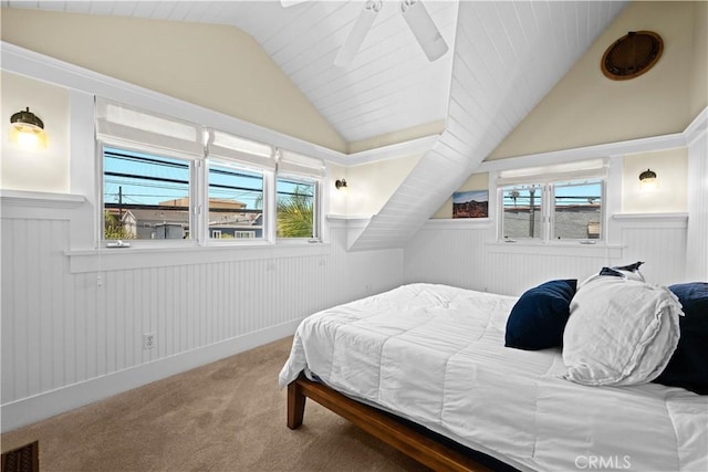 6025 E Ocean Blvd, Long Beach, CA 90803 - carpeted bedroom with wainscoting, vaulted ceiling, multiple windows, and ceiling fan