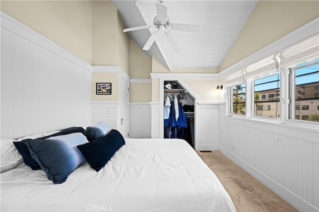 6025 E Ocean Blvd, Long Beach, CA 90803 - carpeted bedroom with lofted ceiling, wainscoting, a ceiling fan, and a closet
