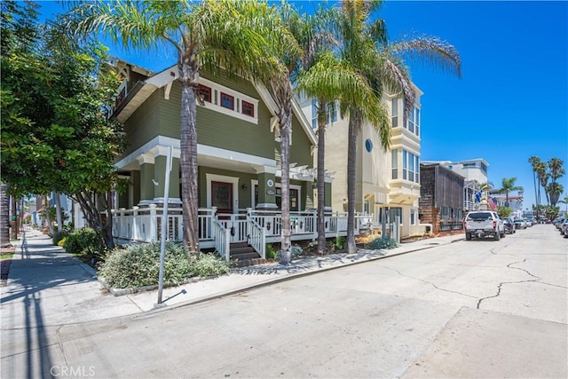 6025 E Ocean Blvd, Long Beach, CA 90803 - view of property with a porch, a residential view, and stucco siding