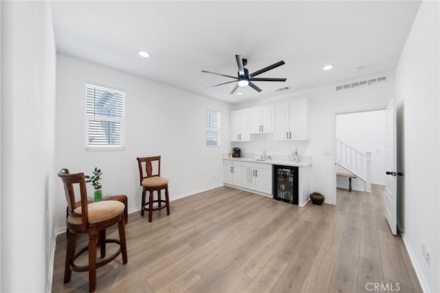 32084 Richardson St, Menifee, CA 92584 - sitting room featuring beverage cooler, recessed lighting, a ceiling fan, light wood-style flooring, and stairway