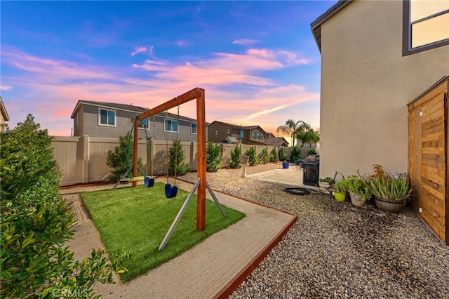 32084 Richardson St, Menifee, CA 92584 - yard at dusk featuring a fenced backyard and a patio area