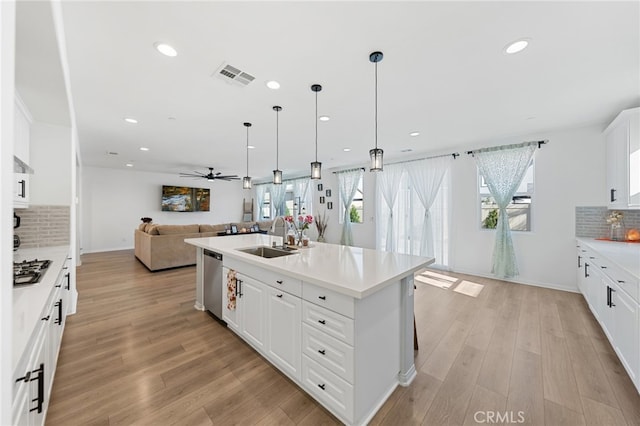 32084 Richardson St, Menifee, CA 92584 - kitchen with open floor plan, dishwasher, tasteful backsplash, light countertops, and recessed lighting