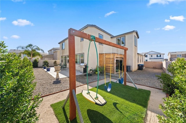32084 Richardson St, Menifee, CA 92584 - rear view of house with stucco siding, a patio, a playground, and a fenced backyard