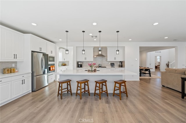 32084 Richardson St, Menifee, CA 92584 - kitchen featuring appliances with stainless steel finishes, wall chimney exhaust hood, recessed lighting, light countertops, and decorative backsplash