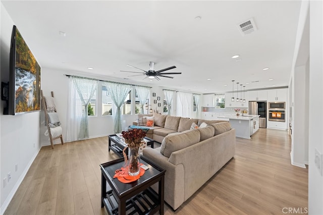 32084 Richardson St, Menifee, CA 92584 - living room with healthy amount of natural light, light wood-type flooring, recessed lighting, and ceiling fan