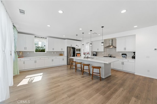 32084 Richardson St, Menifee, CA 92584 - kitchen with wall chimney exhaust hood, smart refrigerator, gas cooktop, built in microwave, and light countertops